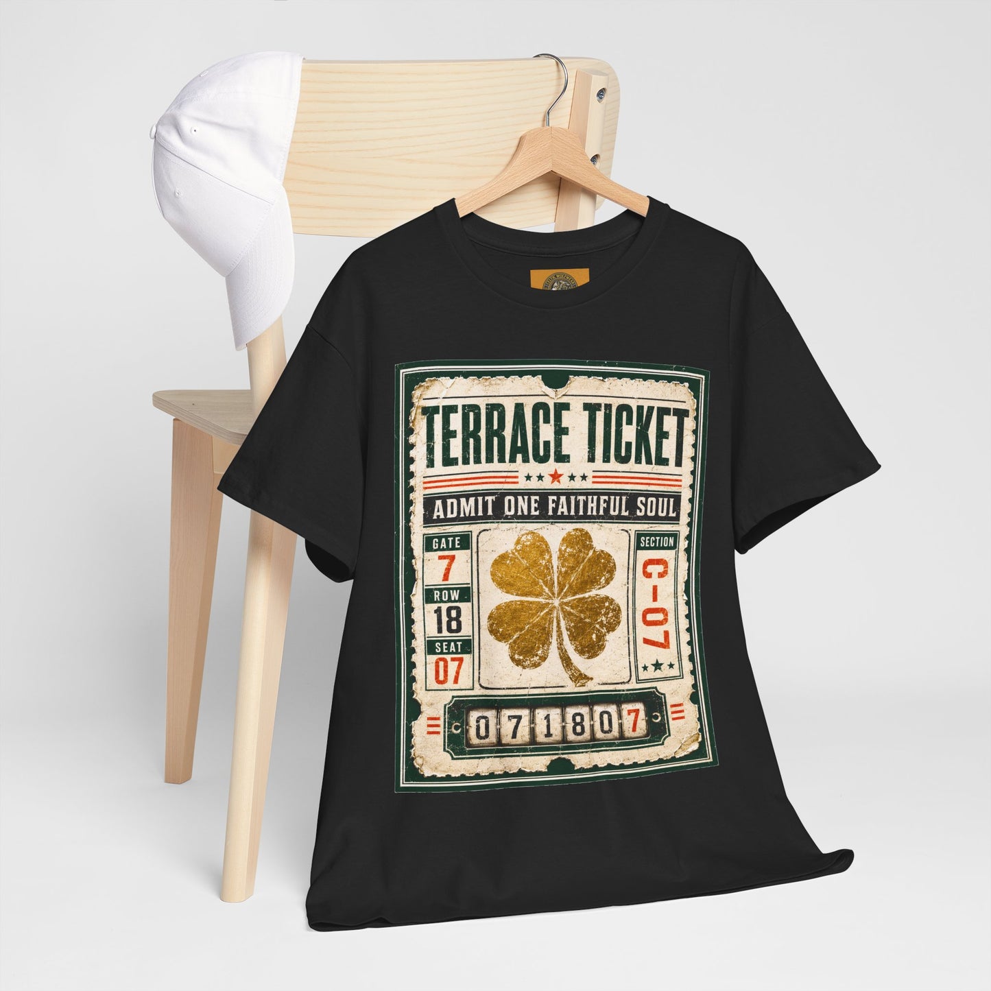 Black T-shirt on hanger with large ticket graphic and gold four-leaf clover