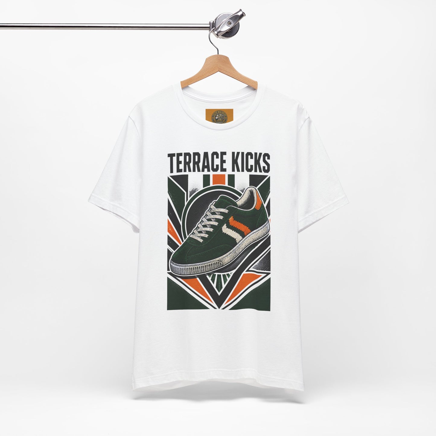 White graphic sneaker tee with “Terrace Kicks” shoe print, hanging on a wooden hanger