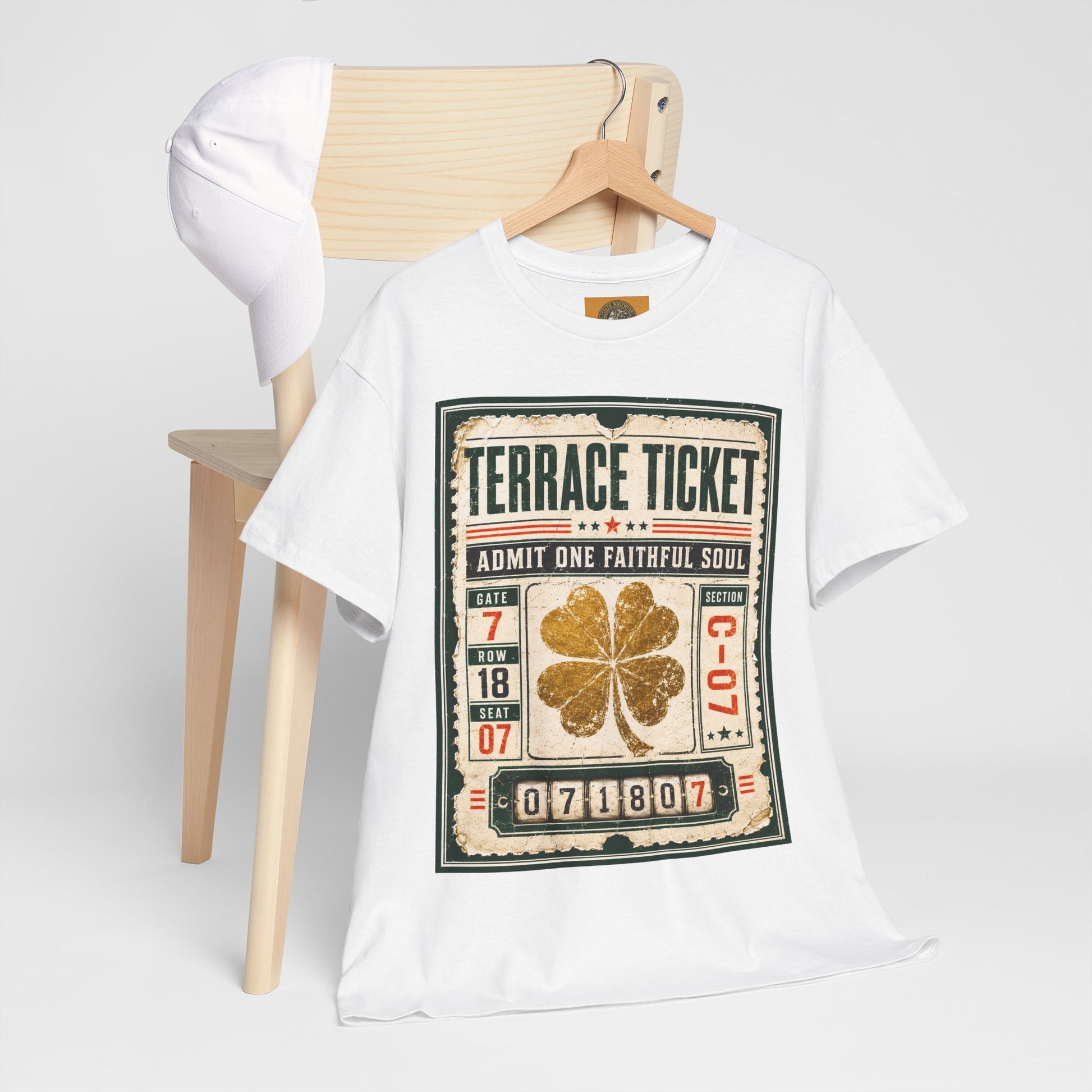 White graphic T-shirt on hanger display, featuring vintage ticket art with gold four-leaf clover.