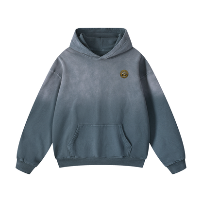 Slate blue oversized hoodie with hood, front pouch pocket, and small chest logo patch