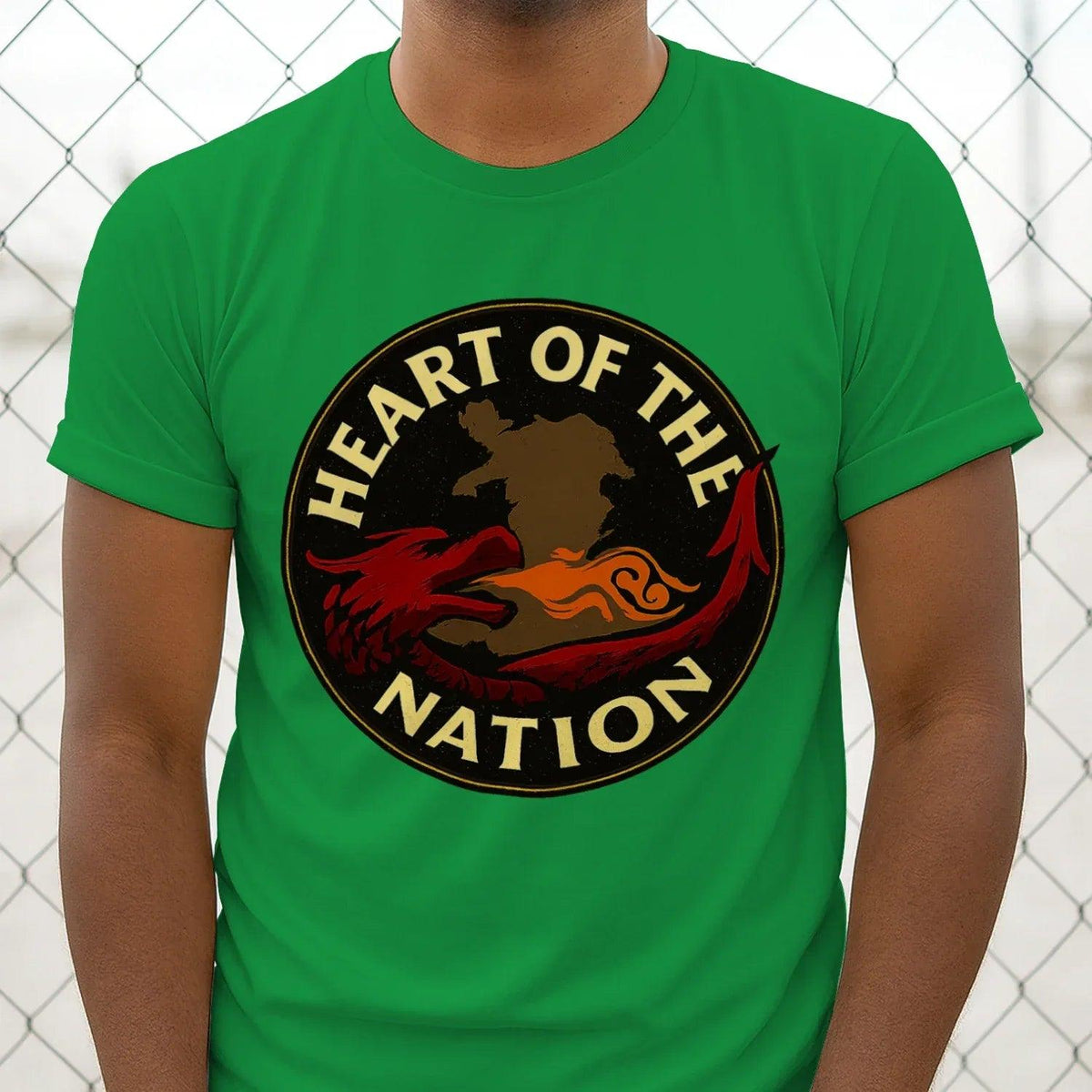Green T-shirt with round “Heart of the Nation” dragon emblem graphic on chest