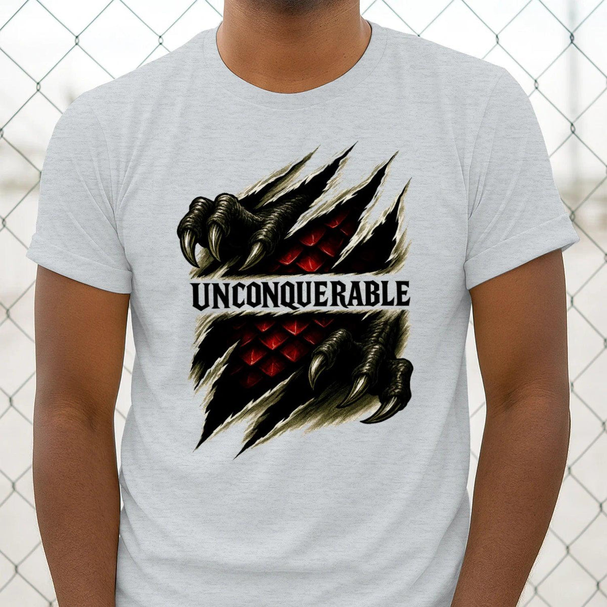 Sport grey crew-neck T-shirt close-up, dragon claw graphic and 'UNCONQUERABLE' text
