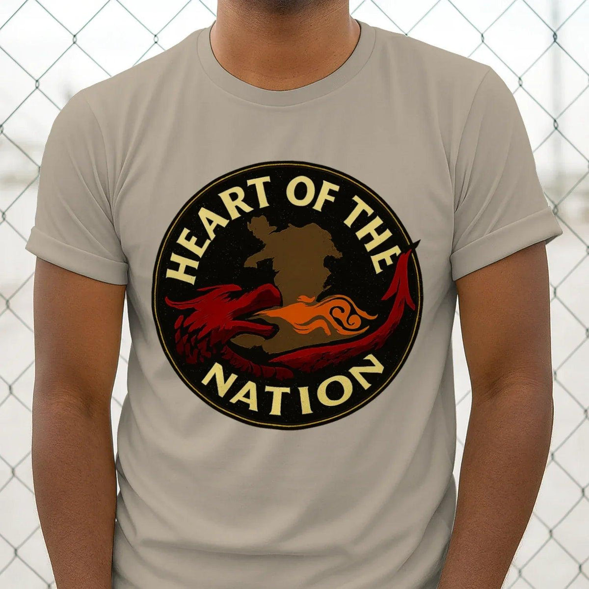 Light beige T-shirt with round “Heart of the Nation” dragon emblem graphic on chest