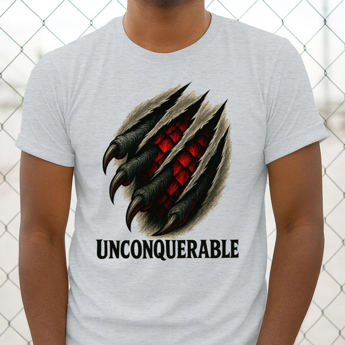 Gray cotton T-shirt with large dragon claw graphic and 'UNCONQUERABLE' text, upper torso