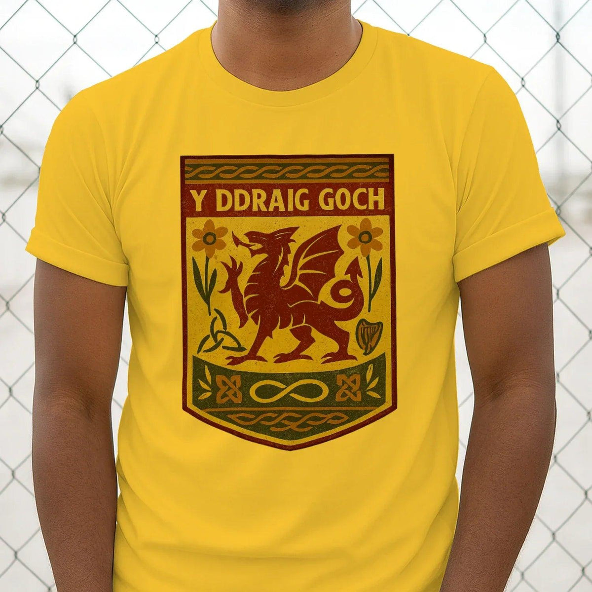 Yellow T-shirt close-up: centered shield graphic with dragon illustration