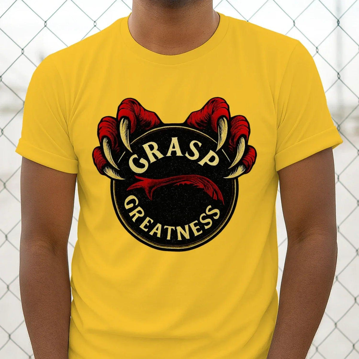 Yellow T-shirt with circular red claws and gold text emblem on chest, close view