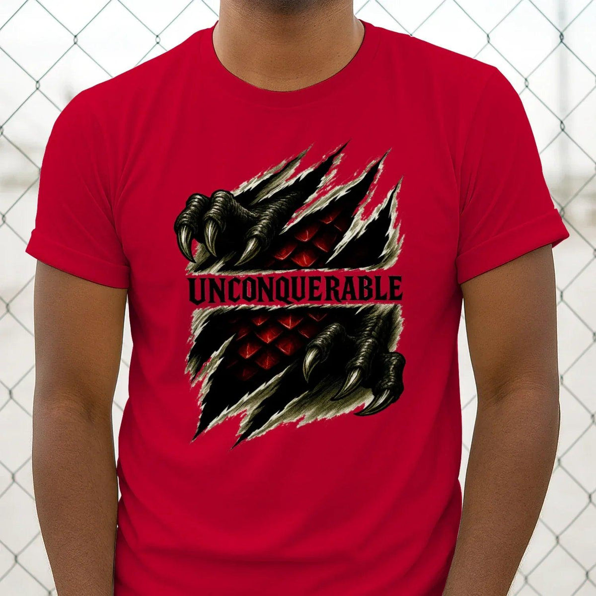 Red crew-neck T-shirt with centered dragon claw graphic and 'UNCONQUERABLE' text
