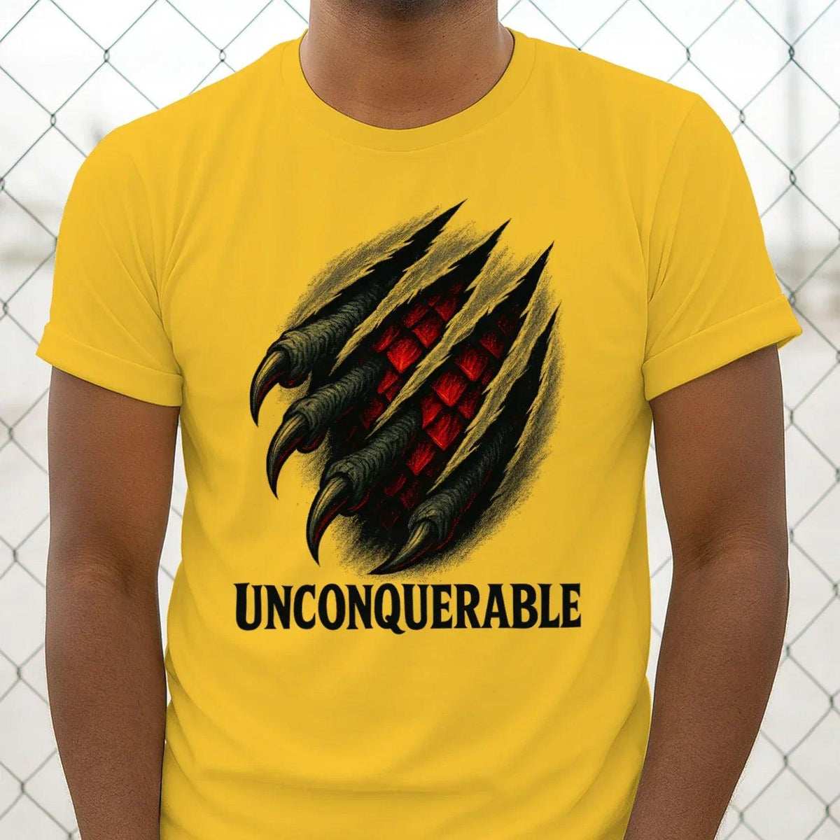 Yellow cotton T-shirt with dragon claw graphic and 'UNCONQUERABLE' print, crew neck.
