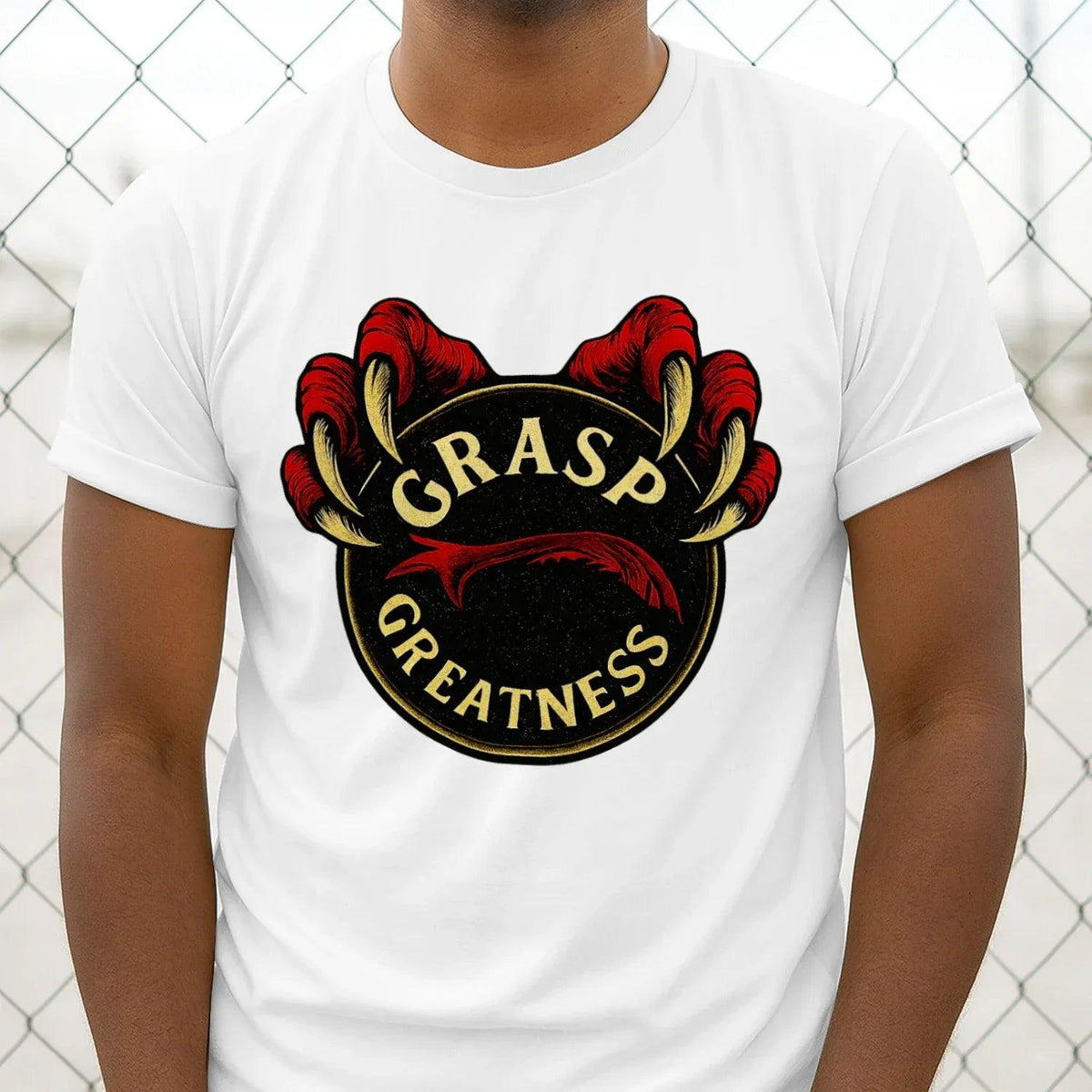 White t-shirt close-up: GRASP GREATNESS crest graphic