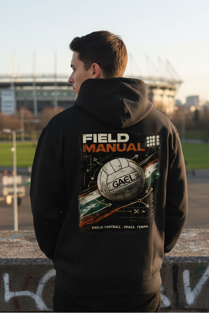 Black unisex hoodie with large back graphic featuring ball and “FIELD MANUAL” text